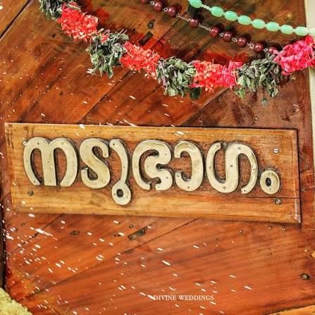 The carved നടുഭാഗം nameplate on the boat's hull